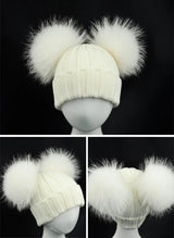 White knit hat with fluffy pom-poms 
